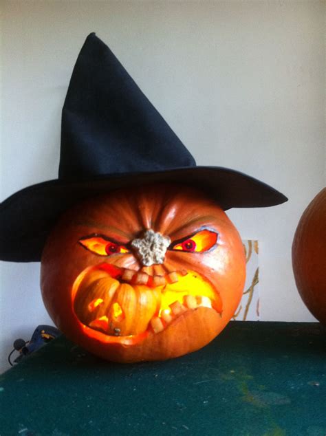 Pumpkin carved as a witch with a hat on top